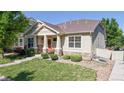 Charming home featuring a welcoming front porch and well-maintained landscaping, with stone accents at 14230 Lakeview Ln, Broomfield, CO 80023
