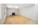 Spacious living room with hardwood floors, modern lighting, and painted brick fireplace, offering a cozy space at 1219 S Yosemite Way # 63, Denver, CO 80247