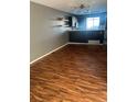 Stylish living area with wood flooring, neutral walls, and an open layout to the modern kitchen at 16901 E Chenango Ave # E, Aurora, CO 80015