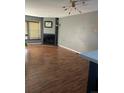 Spacious living room with hardwood floors, cozy fireplace, and ample natural light at 16901 E Chenango Ave # E, Aurora, CO 80015