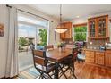 Inviting dining area with a wooden table set, adjacent to a sliding door opening to a deck at 641 Briar Haven Dr, Castle Pines, CO 80108