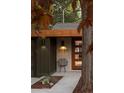 Close up of home's entrance, displaying house number, modern chair and covered entryway at 2060 Hoyt St, Lakewood, CO 80215