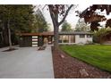 Inviting home with a modern garage, well-maintained lawn, and stylish front door at 2060 Hoyt St, Lakewood, CO 80215