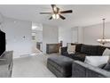 Open-concept living room featuring a large sectional, ceiling fan and access to the kitchen at 11338 Donley Dr, Parker, CO 80138