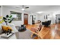 Bright living room boasts hardwood floors and a neutral color palette with lots of natural light at 8881 Lilly Dr, Thornton, CO 80229