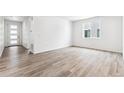 Living room with wood-look floors and an entryway at 4527 Boone Cir, Brighton, CO 80601