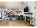 Cozy living room with a fireplace, hardwood floors, and a comfortable seating area at 8394 S Everett Way # E, Littleton, CO 80128