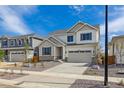 Charming two-story home with neutral siding, stone accents, well-manicured landscaping, and an attached two-car garage at 25234 E Warren Pl, Aurora, CO 80018