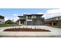 Modern home boasts a two-car garage, clean lines, and xeriscaped front yard, set against a blue sky at 5224 Lions Paw St, Castle Rock, CO 80104