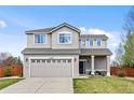 Charming two-story home featuring a well-manicured lawn and an attached two-car garage at 21005 Glacier Park Cv, Parker, CO 80138