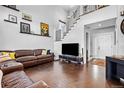 Spacious living room featuring high ceilings, stylish décor, and hardwood flooring at 21005 Glacier Park Cv, Parker, CO 80138