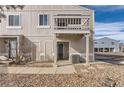 Exterior view of a two-story home showcasing a balcony and well-maintained front yard at 7902 Chase Cir # 152, Arvada, CO 80003