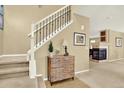 Warm entryway featuring a staircase with wrought iron railings, decorative accents, and neutral tones at 16367 E Auburn Hills Dr, Parker, CO 80134