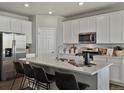 Kitchen boasts stainless steel appliances and white cabinetry at 8953 Rifle St, Commerce City, CO 80022