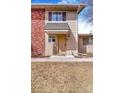 Charming home exterior with brick accents, covered entry, and well-maintained landscaping at 2279 Coronado Pkwy # B, Denver, CO 80229