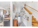 Inviting hallway with built-in shelving, tiled flooring, and natural light leading to the home's backyard at 2279 Coronado Pkwy # B, Denver, CO 80229