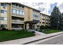 Well maintained multi-unit building with mature landscaping and inviting entryway on a sunny day at 695 S Alton Way # 5A, Denver, CO 80247
