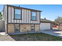 Charming two-story home featuring brick accents, a two-car garage, and a well-maintained front yard at 5202 Dillon St, Denver, CO 80239