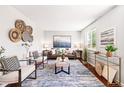 Bright living room with modern furnishings, stylish decor, and a large window for natural light at 5202 Dillon St, Denver, CO 80239