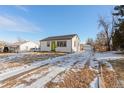 Charming Ranch home exterior, featuring a green door and attached garage at 1846 S Lowell Blvd, Denver, CO 80219