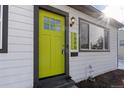 Eye-catching bright green front door with gray trim at 1846 S Lowell Blvd, Denver, CO 80219