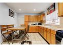 Eat-in kitchen featuring wooden cabinets, tile countertops, and tile flooring at 4024 W Kentucky Ave # A And B, Denver, CO 80219