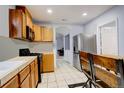 Eat-in kitchen featuring wooden cabinets, stainless steel appliances, and tile flooring at 4024 W Kentucky Ave # A And B, Denver, CO 80219