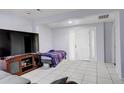 Living room with white walls, tile floors, and a bright white front door at 4024 W Kentucky Ave # A And B, Denver, CO 80219