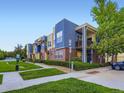 Multi-colored condo building with patios, brick accents, and a well-maintained lawn at 11316 Colony Cir, Broomfield, CO 80021