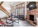 Living room with fireplace, and view into dining room at 4251 S Fairplay Cir # E, Aurora, CO 80014