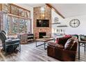 Spacious living room with a brick fireplace and large windows at 4251 S Fairplay Cir # E, Aurora, CO 80014