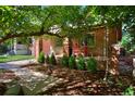 Charming front porch with red chairs and lush landscaping at 1445 Elm St, Denver, CO 80220