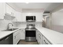 Updated kitchen featuring stainless steel appliances and white cabinetry at 3663 S Sheridan Blvd # 2, Denver, CO 80235