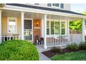 Inviting front porch with white railings, decorative lanterns, and a cozy seating area for relaxing outdoors at 6829 S Niagara Ct, Centennial, CO 80112