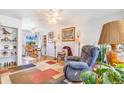 Cozy living room with hardwood floors and a view into the adjacent dining area at 5085 E Missouri Ave, Denver, CO 80246