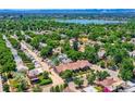 Stunning aerial view of the neighborhood with lush trees, single-Gathering homes, and a lake in the distance at 3922 W 29Th Ave, Denver, CO 80212