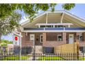 Charming brick home featuring a symmetrical facade, wrought iron fence, and inviting entryway at 3922 W 29Th Ave, Denver, CO 80212