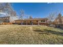 Expansive backyard with a covered patio, ideal for outdoor gatherings and enjoying the surrounding greenery at 6259 S Fenton Ct, Littleton, CO 80123