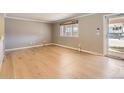 Light-filled room with hardwood floors and a sliding glass door to the exterior at 6259 S Fenton Ct, Littleton, CO 80123