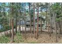 Two-story home with a two-car garage, charming front porch, and surrounded by beautiful trees at 17865 Smugglers Rd, Monument, CO 80132