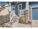 Cozy front porch with stone columns and a white wood railing, provides a welcoming entry at 2649 Westgate Ave, Highlands Ranch, CO 80126