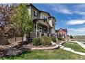 Charming two-story home features a welcoming front porch, stone accents, and well-manicured landscaping at 3429 Hardin St, Castle Rock, CO 80109