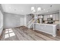Bright living space features sleek, open-concept design, modern lighting, and beautiful wood floors at 3429 Hardin St, Castle Rock, CO 80109