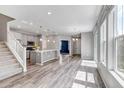 Spacious living room featuring an open floorplan, light gray cabinets, and new hardwood floors at 3429 Hardin St, Castle Rock, CO 80109