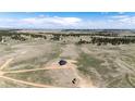 Expansive aerial view showcasing a modern home nestled within a vast, scenic landscape at 37094 Still Rock Pt, Elizabeth, CO 80107