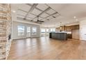 Open-concept living room featuring a stone fireplace and access to the kitchen with a large island at 37094 Still Rock Pt, Elizabeth, CO 80107