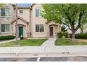 Charming townhome exterior featuring stone accents, manicured lawn, and inviting entryway with well maintained landscaping at 12770 Jasmine Ct, Thornton, CO 80602