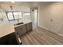 This modern kitchen features stainless steel appliances and luxury vinyl plank flooring at 100 Park Ave # 1405, Denver, CO 80205