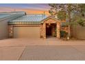 Charming home featuring a stone facade, two car garage and well-lit entrance at 867 Hill And Dale Rd # B, Golden, CO 80401