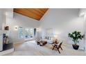 Inviting living room with vaulted wood ceilings, fireplace, and a walk-out balcony at 867 Hill And Dale Rd # B, Golden, CO 80401